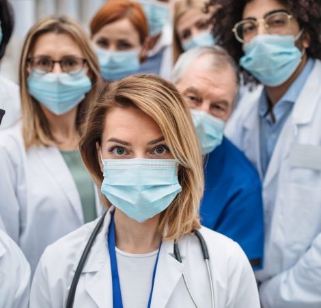 group-of-doctors-with-face-masks-looking-at-camera-ZAL8RZC.jpg